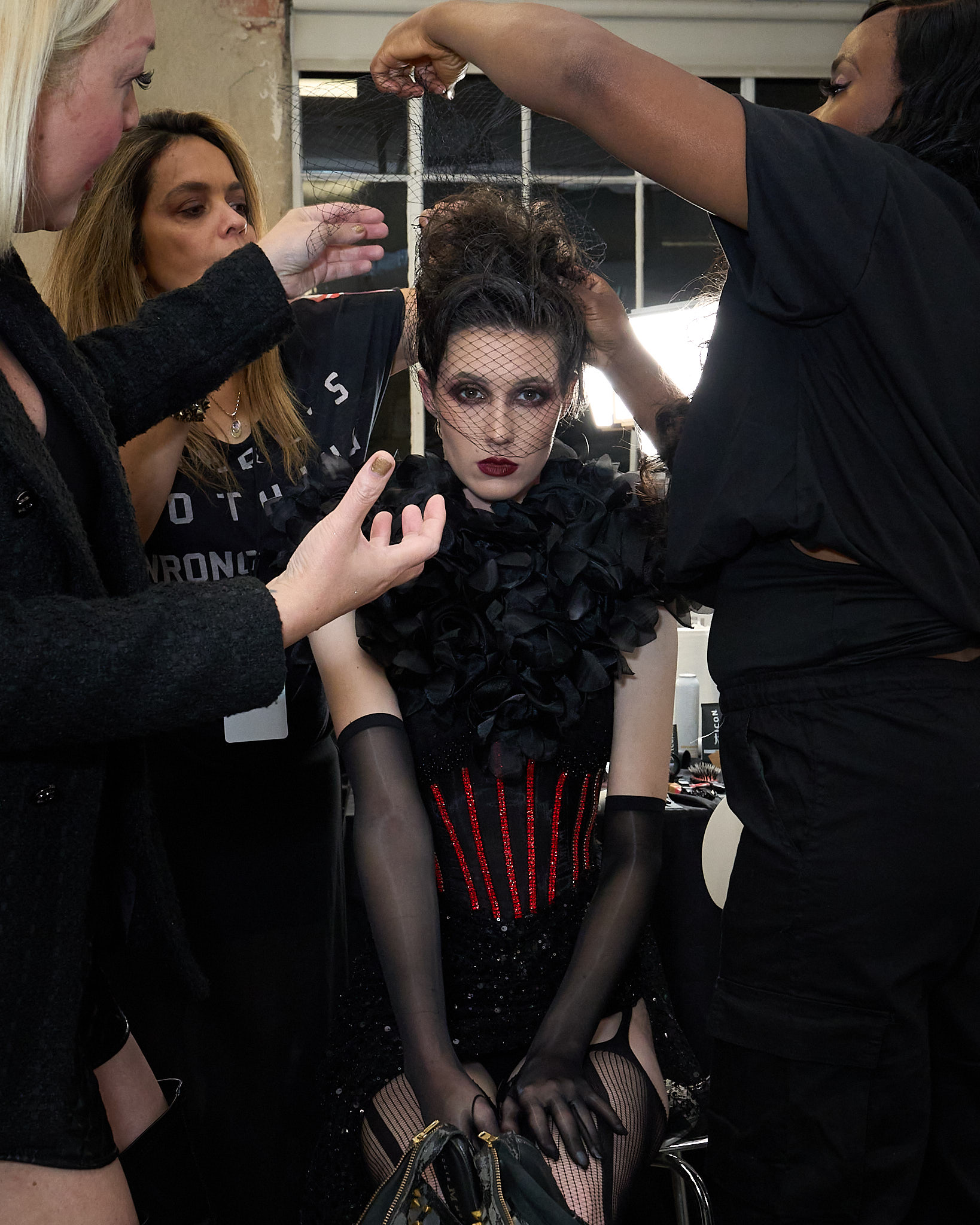 Stylists preparing a model backstage at Los Angeles Fashion Week