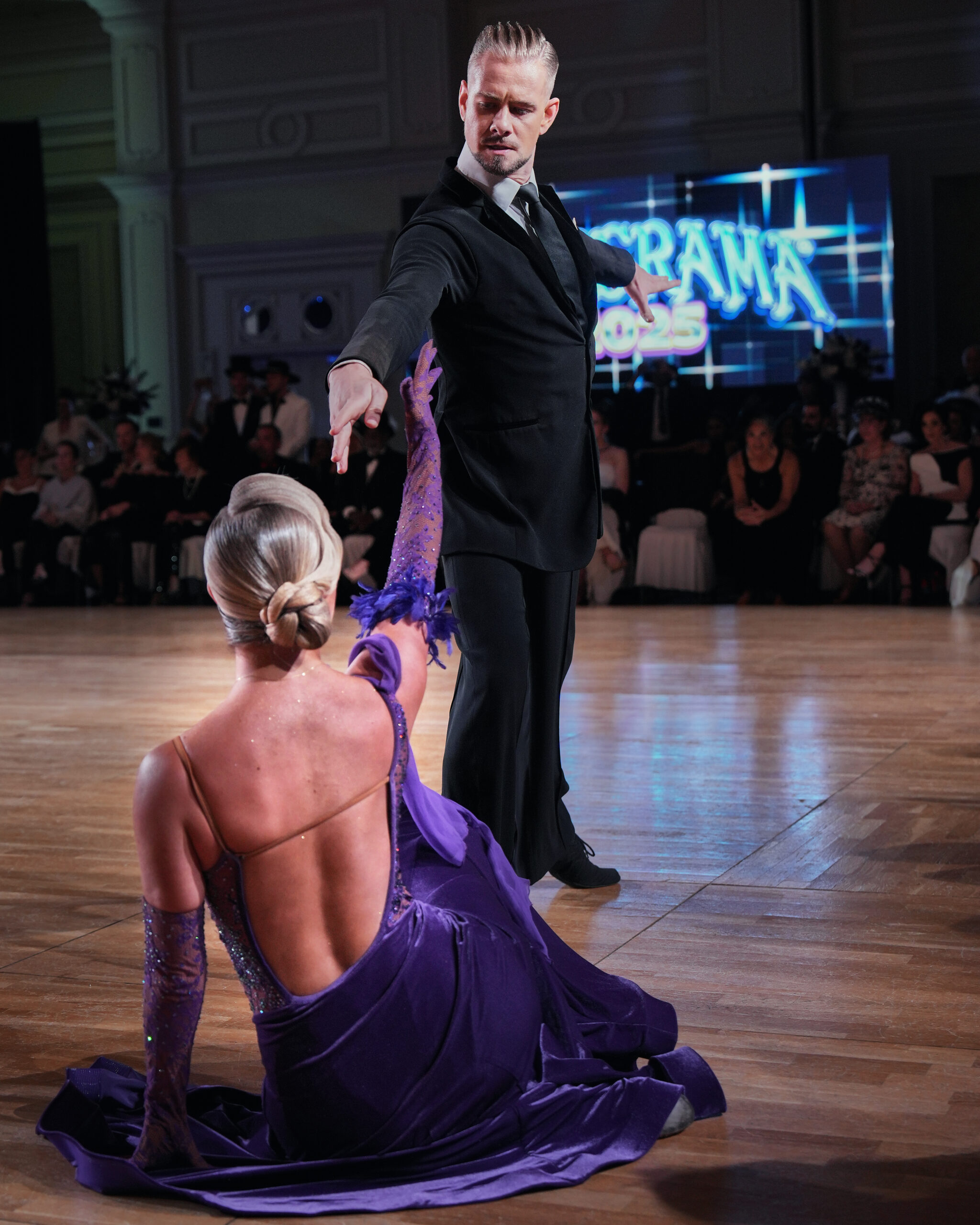 Ballroom dancers performing in front of an audience